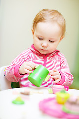 Image showing Toddler girl playing with toys