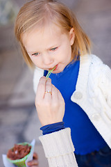 Image showing Little girl eating ice cream