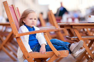 Image showing Little girl at outdoor cafe