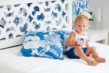 Image showing Portrait of toddler girl sitting on bed