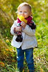 Image showing Toddler girl with yellow leave