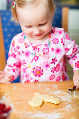 Image showing Little girl baking cookies