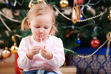 Image showing Toddler girl with Christmas candy