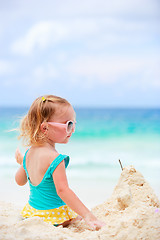 Image showing Little girl playing with sand