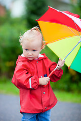 Image showing Toddler girl with umbrella outdoors on rainy day