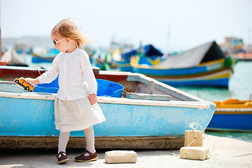 Image showing Little girl playing with toy bus