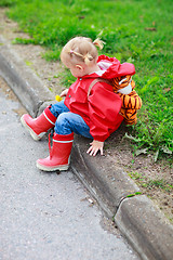 Image showing Toddler girl outdoor at rainy day