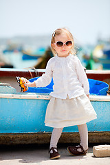 Image showing Little girl playing with toy bus