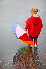 Image showing Toddler girl outdoors at rainy day