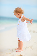 Image showing Toddler girl in white dress at beach