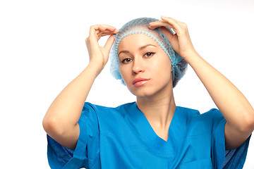 Image showing nurse adjusts hat