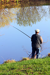 Image showing fishing senior on lake