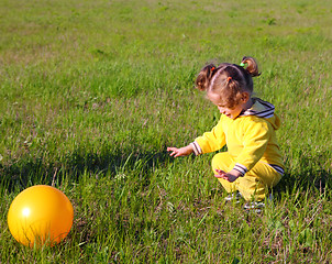 Image showing little girl with ball on meadow