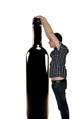 Image showing Man reaching for wine bottle