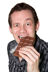 Image showing Man eating a mighty hard chocolate