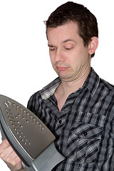 Image showing Man looking on a iron and wondering