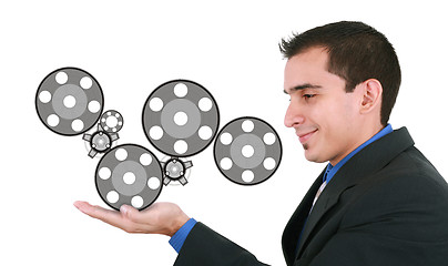 Image showing Businessman holding some mechanisms in his hands 