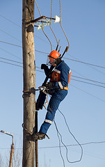 Image showing Electrician working at height with wires