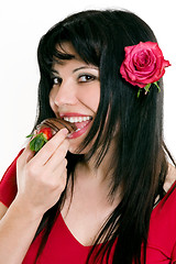 Image showing Female eating fresh strawberries in chocolate