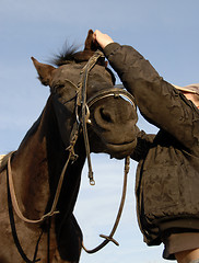 Image showing teenager , bridle and her horse