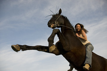 Image showing happy girl and rearing stallion