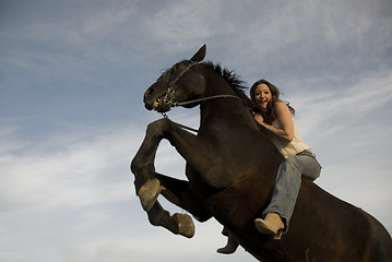 Image showing happy girl and rearing stallion