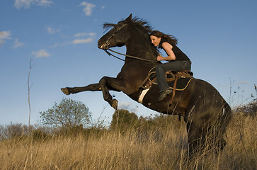 Image showing rearing stallion and girl