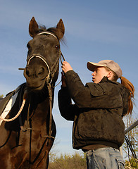 Image showing teenager, bridle and horse