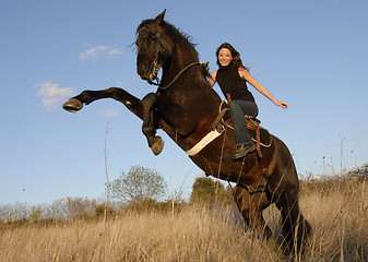 Image showing rearing stallion and girl