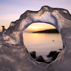 Image showing Sunset through ice's hole