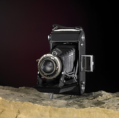 Image showing nostalgic camera on stone surface