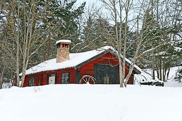 Image showing Rustic red wooden barn in snow