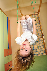 Image showing little girl hanging down at gym