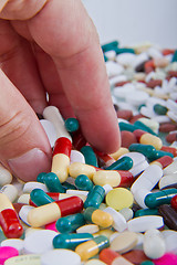 Image showing hand grabbing pills