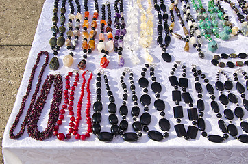 Image showing Earrings table sale market decor jewelry stones 