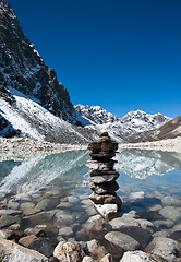 Image showing Harmony: Stone stack and Sacred Lake near Gokyo