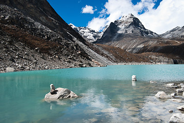 Image showing Pebble stacks and Sacred Lake near Gokyo