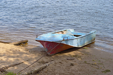 Image showing Metal boat on the riverbank