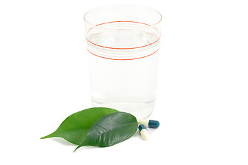 Image showing Pills Medicine Capsules and glass with green leaves Bio