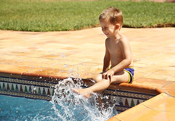 Image showing Happy boy having a fun at swimming pool
