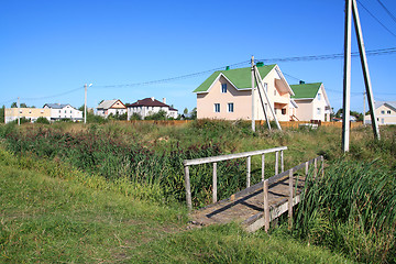 Image showing wooden bridge near new cottages