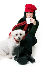 Image showing Woman relaxing with a small pet dog