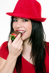Image showing Girl eating strawberries