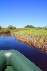 Image showing green boat on small river