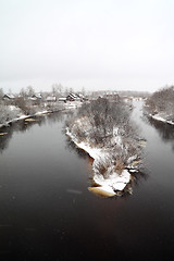 Image showing snow village on coast river 