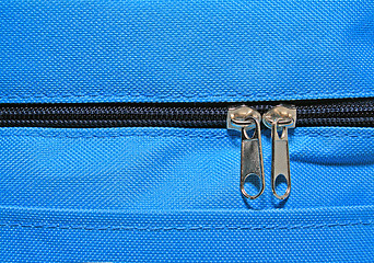 Image showing metallic zipper on blue fabrics