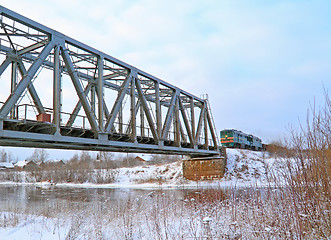 Image showing train on bridge through river 