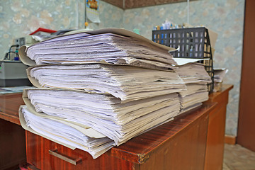 Image showing heap of the papers on table in office