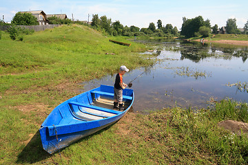 Image showing boy fishes on coast river