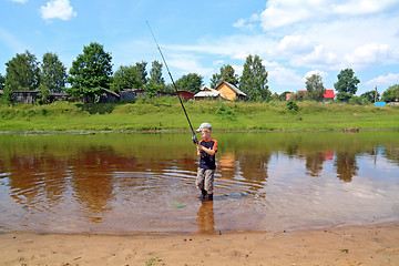 Image showing boy fishes on coast river